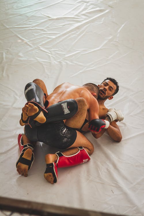 two man fighting in mma cage